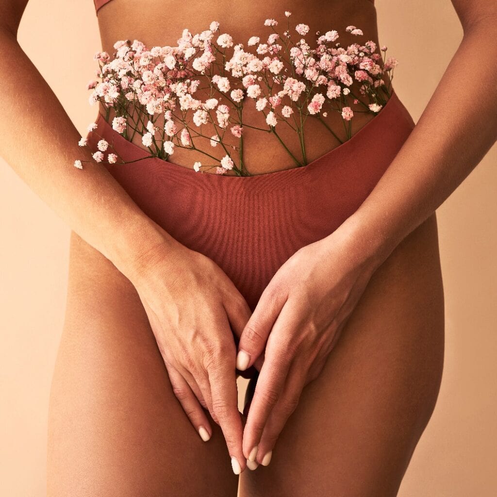 Cropped image of woman in lingerie with flowers made of panties.Women's health and care.
